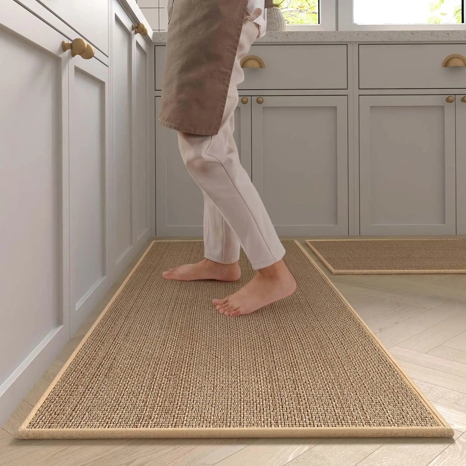 Person stepping onto a woven mat in a kitchen setting