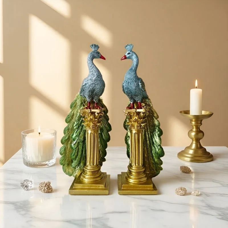 Decorative peacock statues on columns with candles in a warm setting