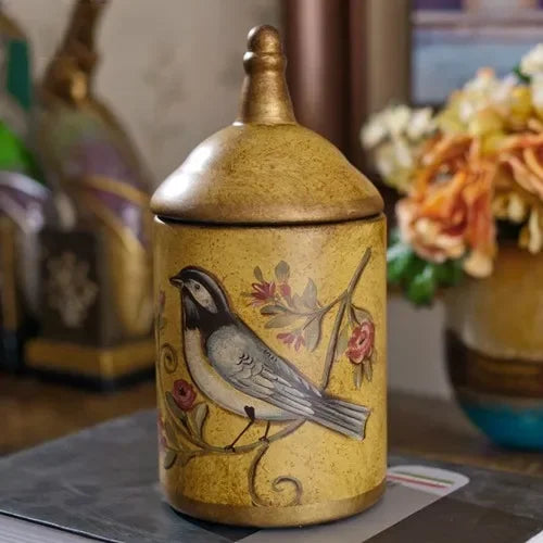 Decorative jar with a bird design on a table