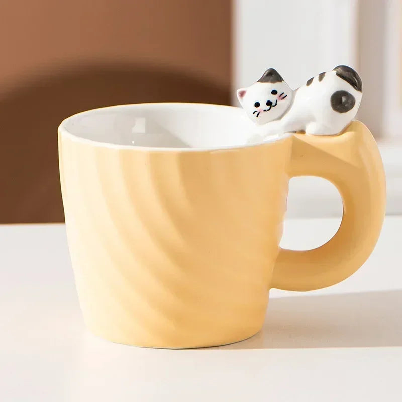 Yellow mug with a cat-shaped object on a white surface