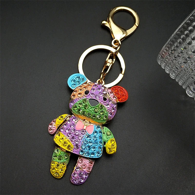 Colorful teddy bear keychain with rhinestones on a dark background