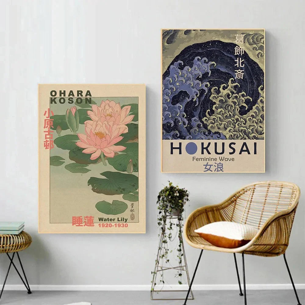 Two framed artworks on a wall with a wicker chair and plant below.