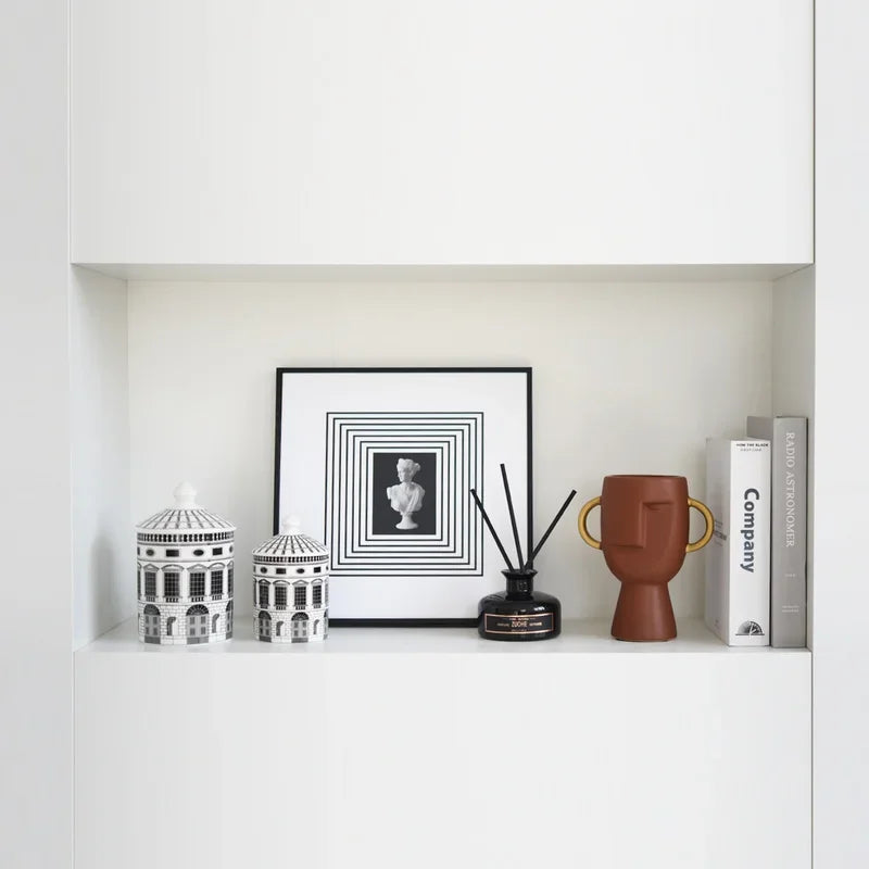 Black and white architectural ceramic storage jar with a decorative lidded design, ideal for storing jewellery, cotton pads and small accessories while adding a stylish accent to modern interiors.