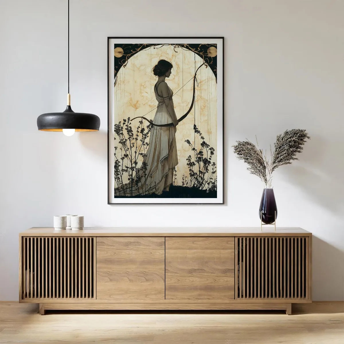 Framed artwork of a woman with a bow and arrow on a wall above a wooden sideboard.