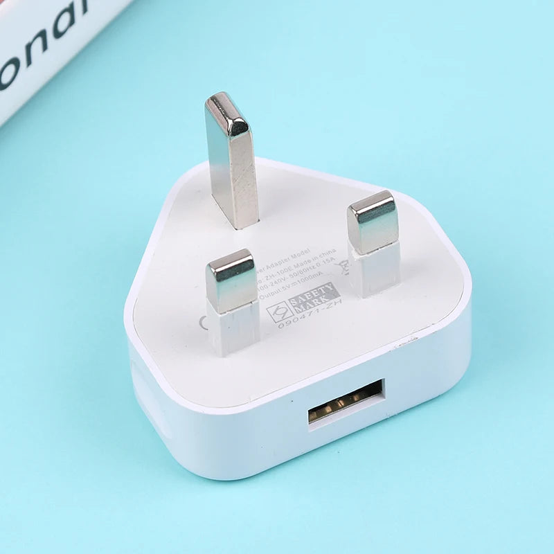 White USB adapter with three prongs on a light blue background