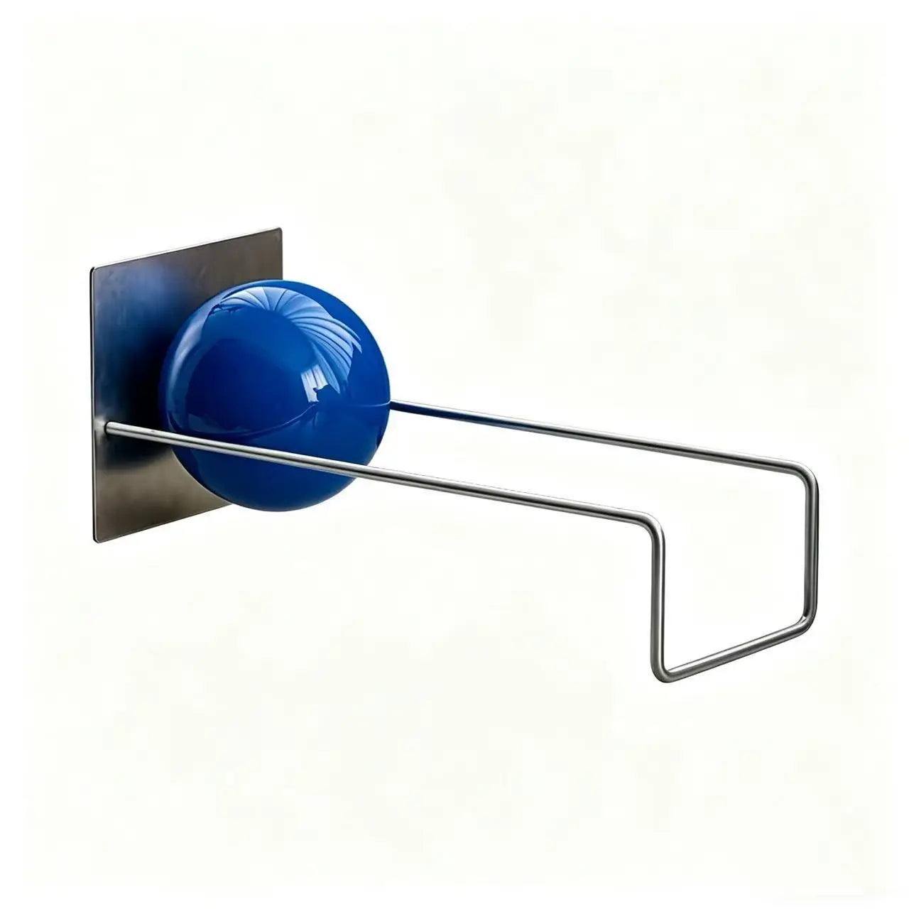 Modern metal desktop bookshelf with blue decorative sphere holding books on a contemporary white desk.