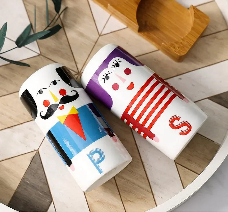 Creative ceramic salt and pepper shaker set with character faces displayed on a wooden holder for stylish kitchen and dining table decor.
