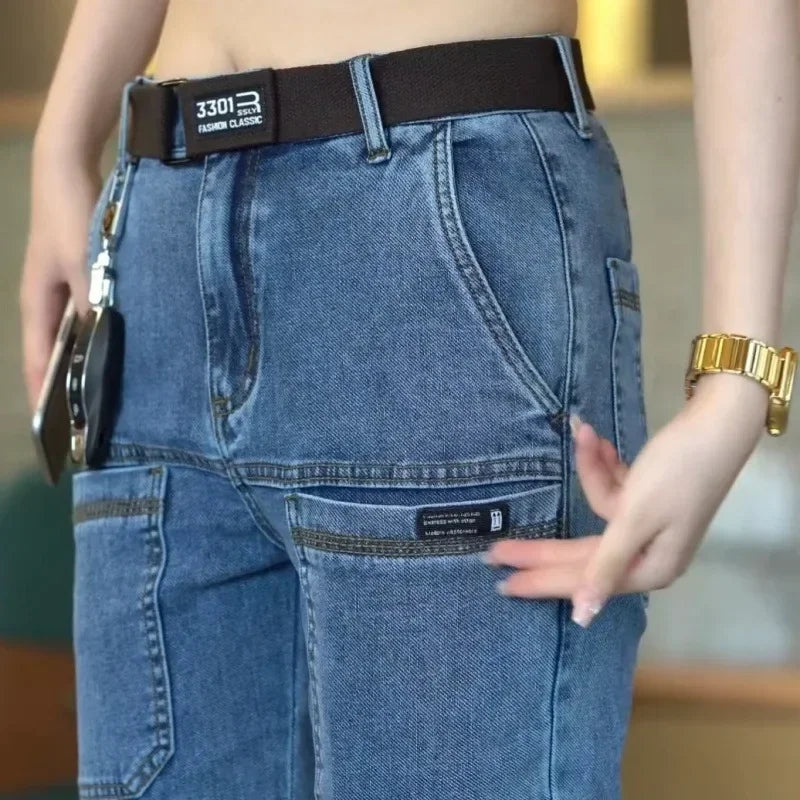 Close-up of blue jeans with a belt and keys, blurred background