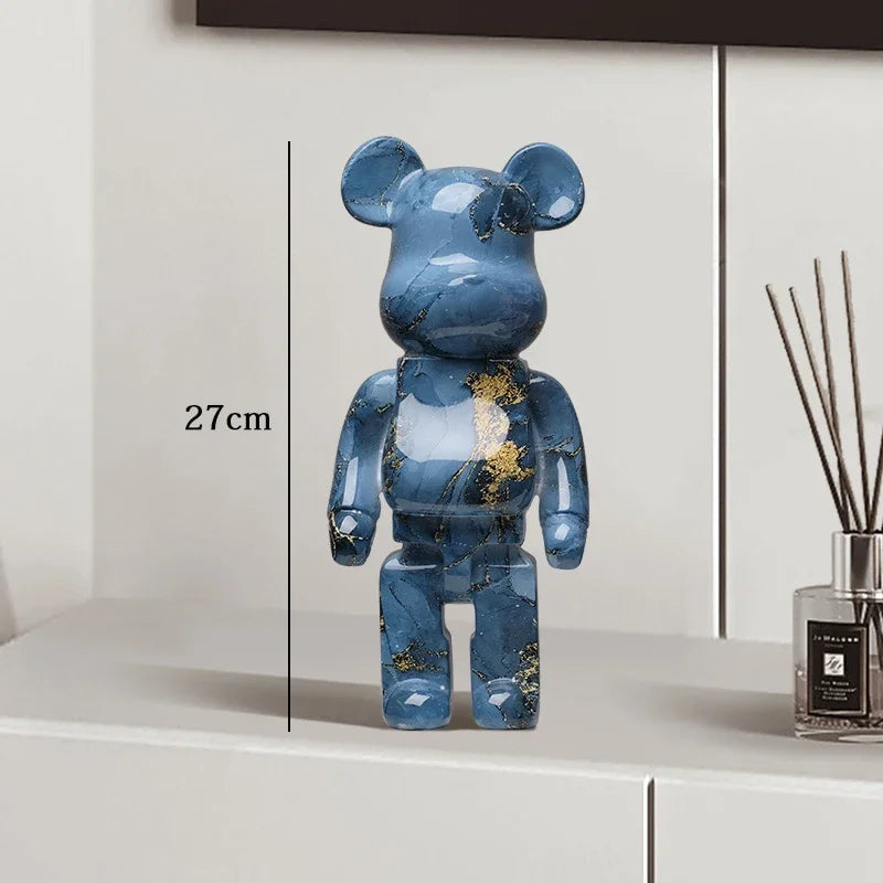 Blue marble-patterned bear figure on a white surface with a diffuser in the background