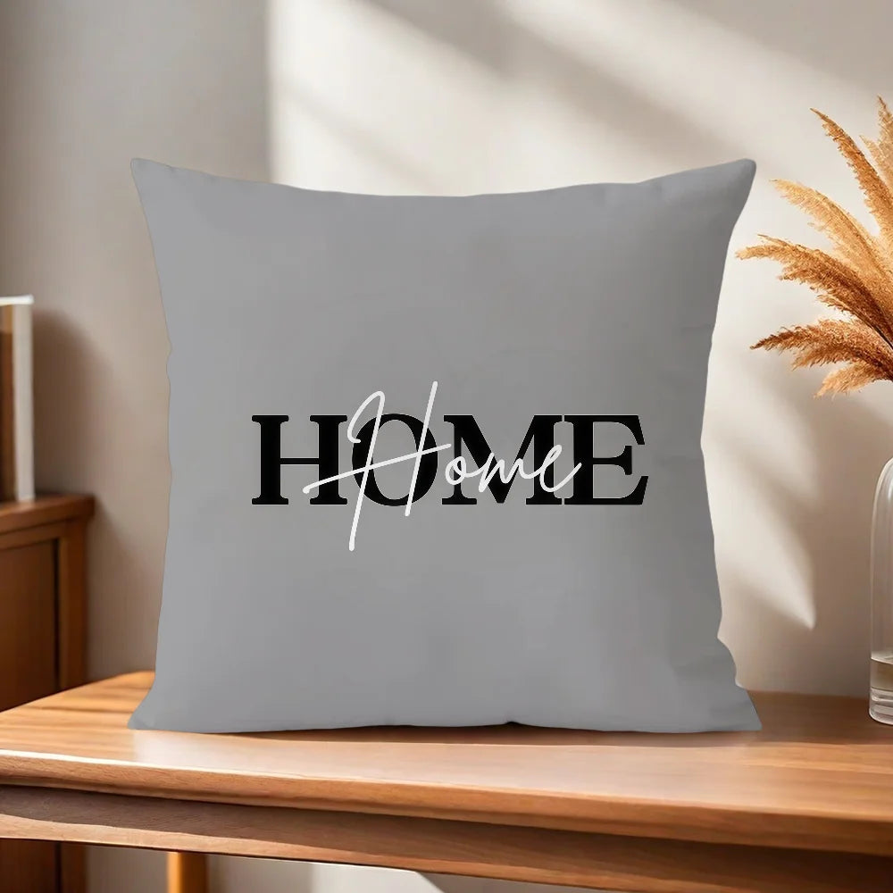 Gray pillow with 'HOME' text on a wooden surface