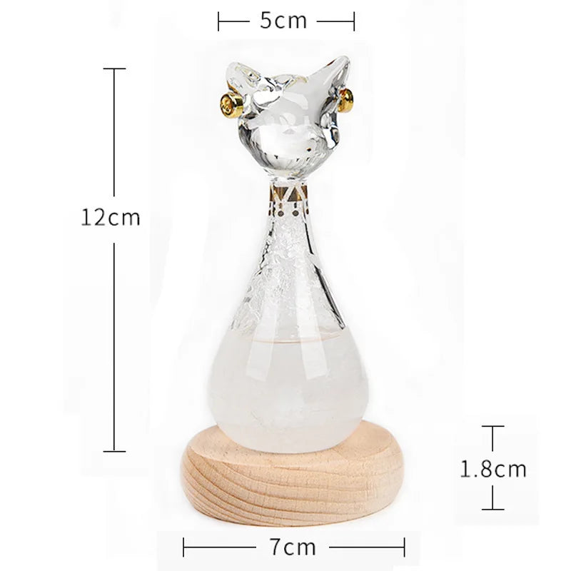 Glass cat-shaped object with wooden base and measurements on a white background
