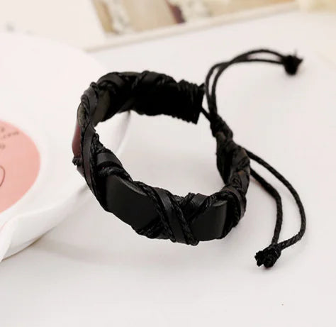 Black braided bracelet on a white surface