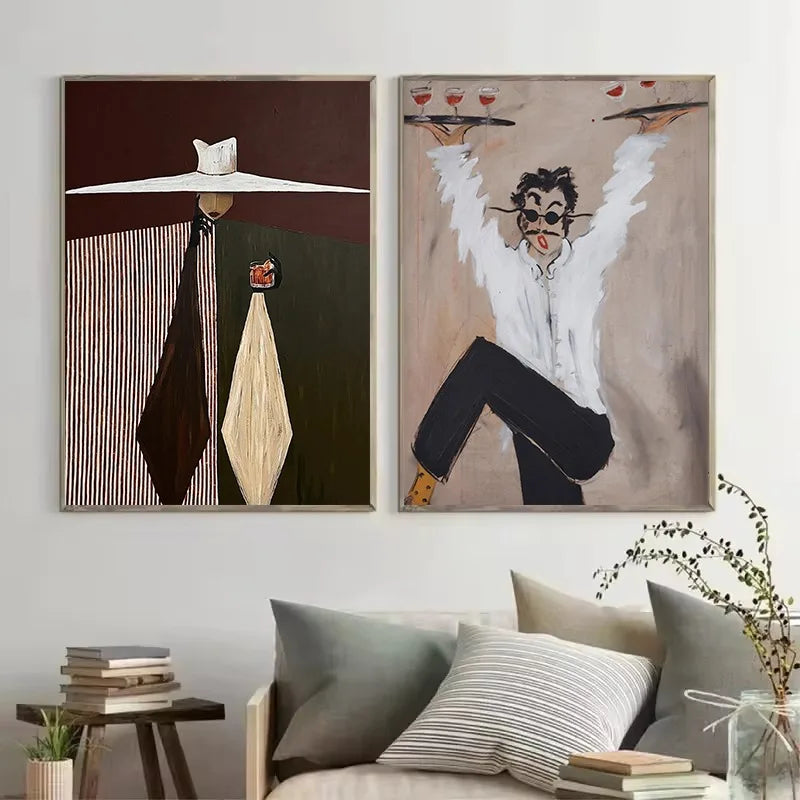 Two abstract art pieces on a wall above a sofa with decorative pillows.