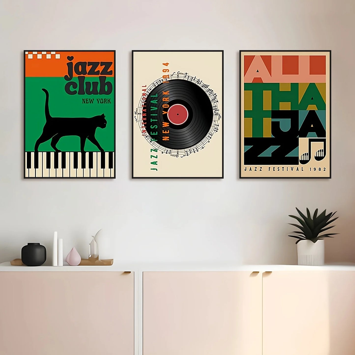 Three jazz-themed posters on a wall above a white cabinet.