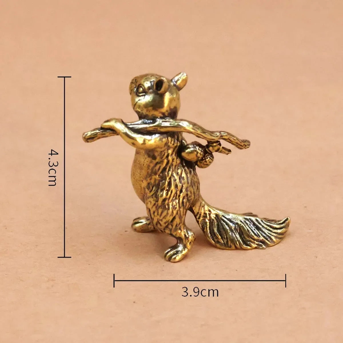 Small brass animal ornament figurine with detailed finish placed on a desk as decorative accent