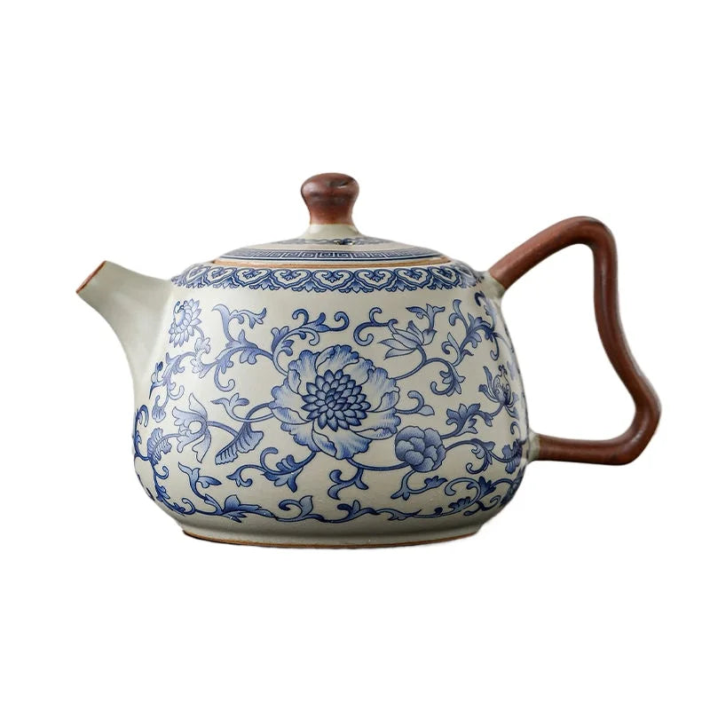 Ceramic teapot with blue floral patterns on a white background