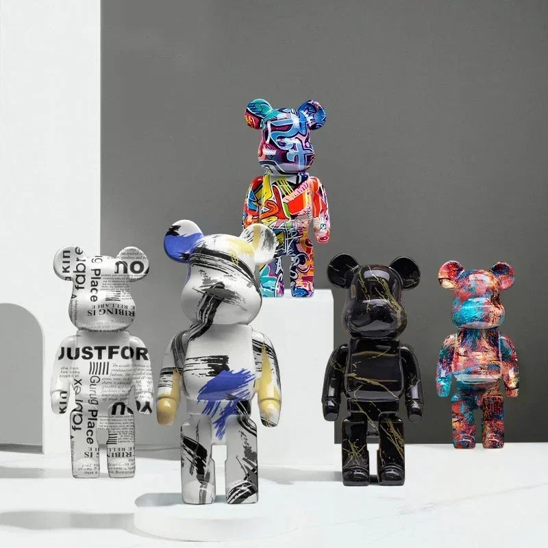 Five colorful bear figurines with various designs on a gray background
