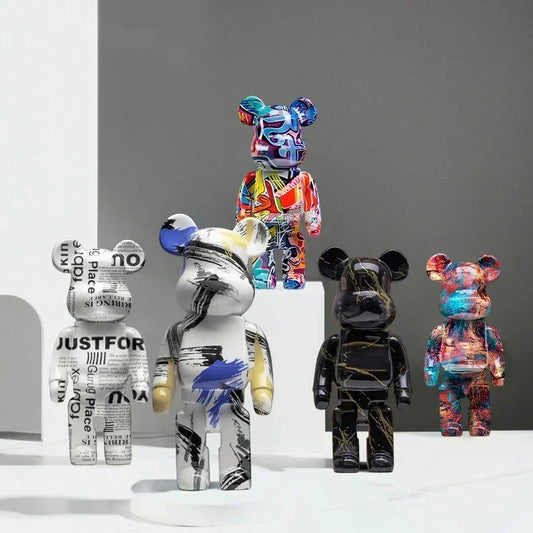 Five colorful bear figurines with various designs on a gray background