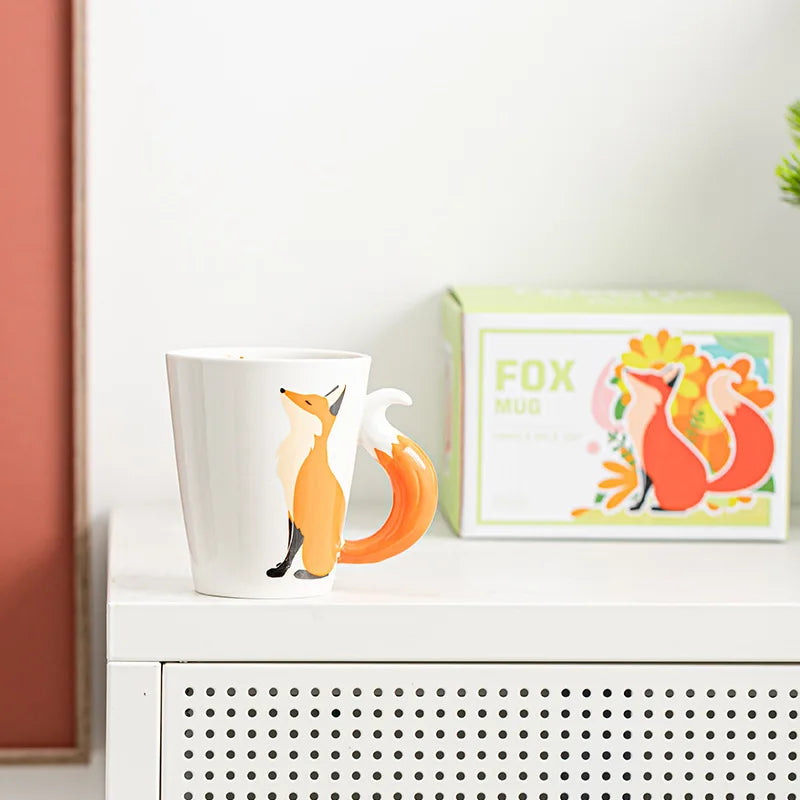 Fox-themed mug and packaging on a white surface with a light background