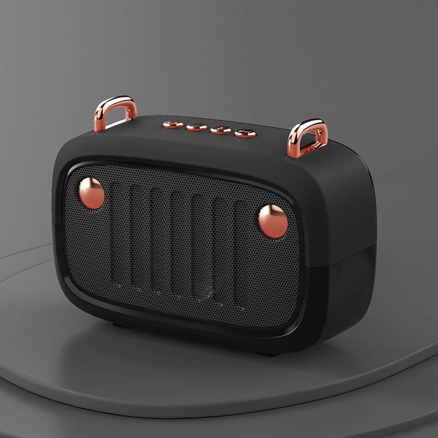 Black portable speaker with rose gold accents on a dark gray background