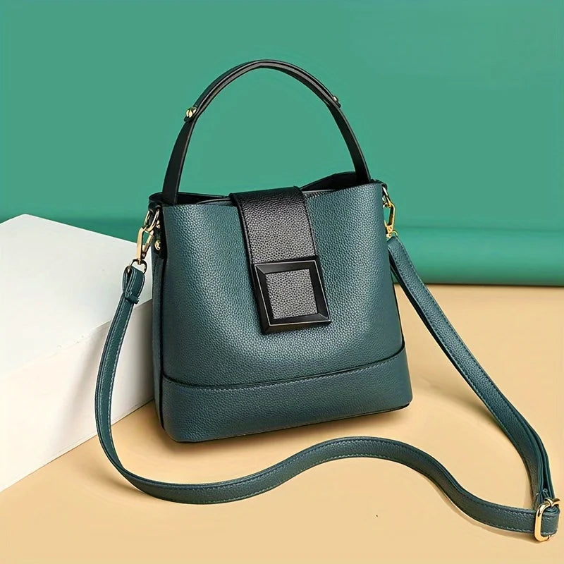 Green handbag with a strap on a beige and green background