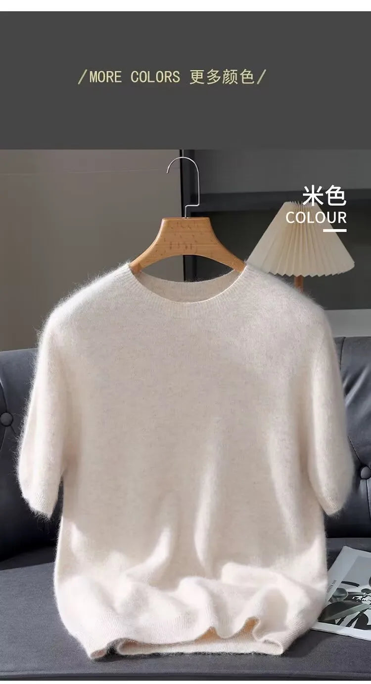 White sweater on a hanger against a gray background with text indicating more color options.