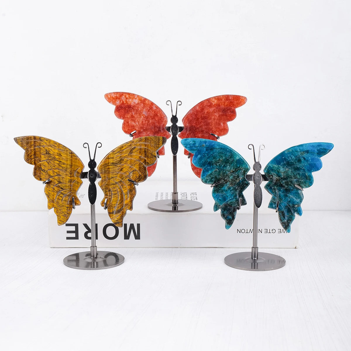 Colorful butterfly-shaped objects on stands with a 'More' text box in the background.