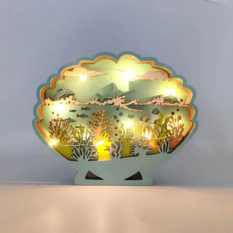 Decorative light fixture shaped like a shell with underwater scene design on a white background