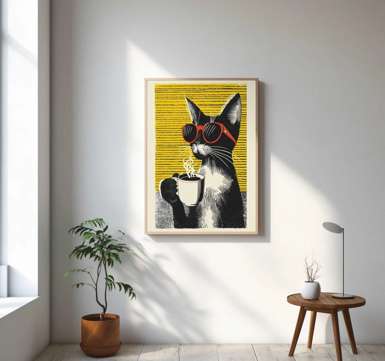 Framed artwork of a cat with sunglasses holding a cup on a yellow background, displayed in a bright room.