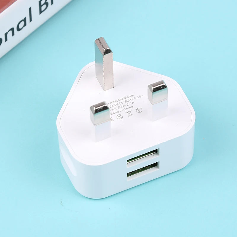 White USB power adapter with two ports on a light blue background