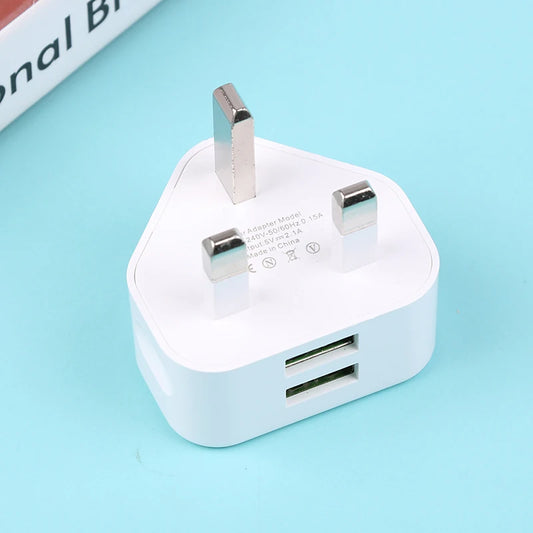 White USB power adapter with two ports on a light blue background