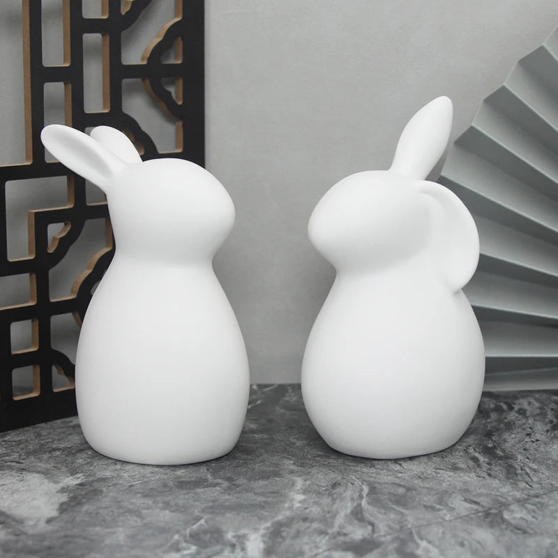 Minimalist white ceramic rabbit figurines with Nordic home decor styling on modern shelf display