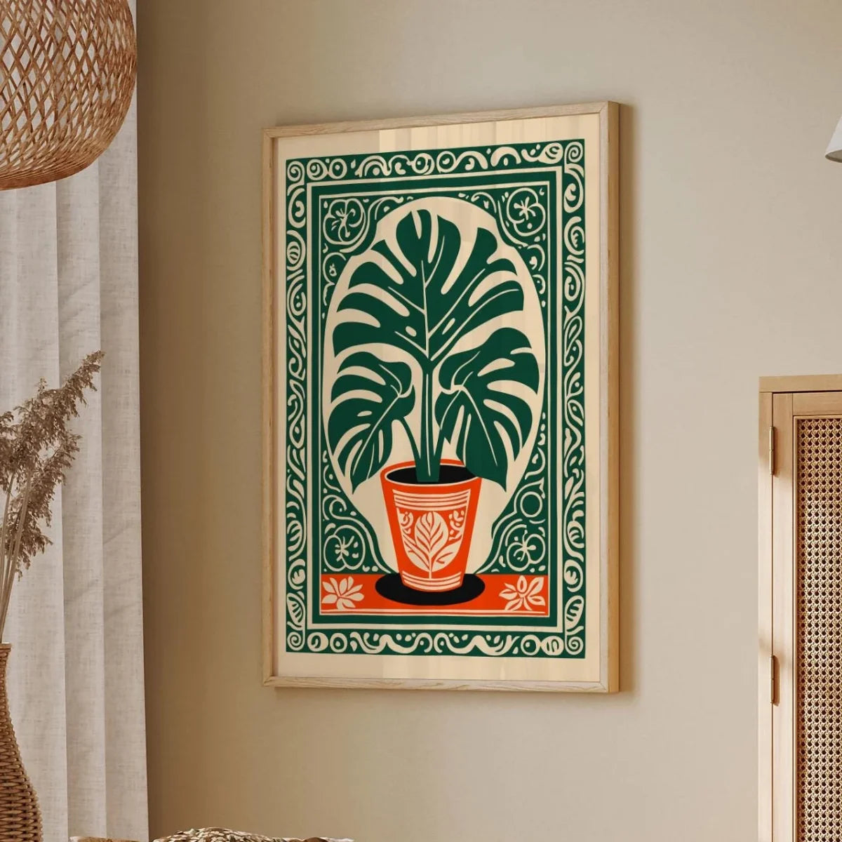 Decorative wall art with a plant design in a wooden frame on a beige wall.