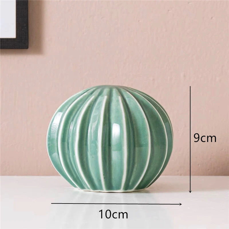 Green ceramic ball with measurements on a pink background