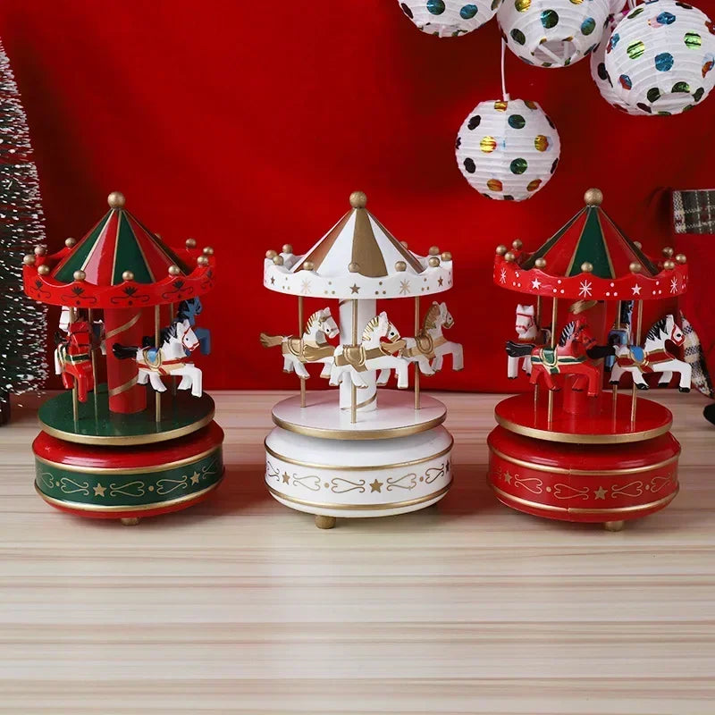 Three decorative carousel models on a wooden surface with a red background and festive decorations.