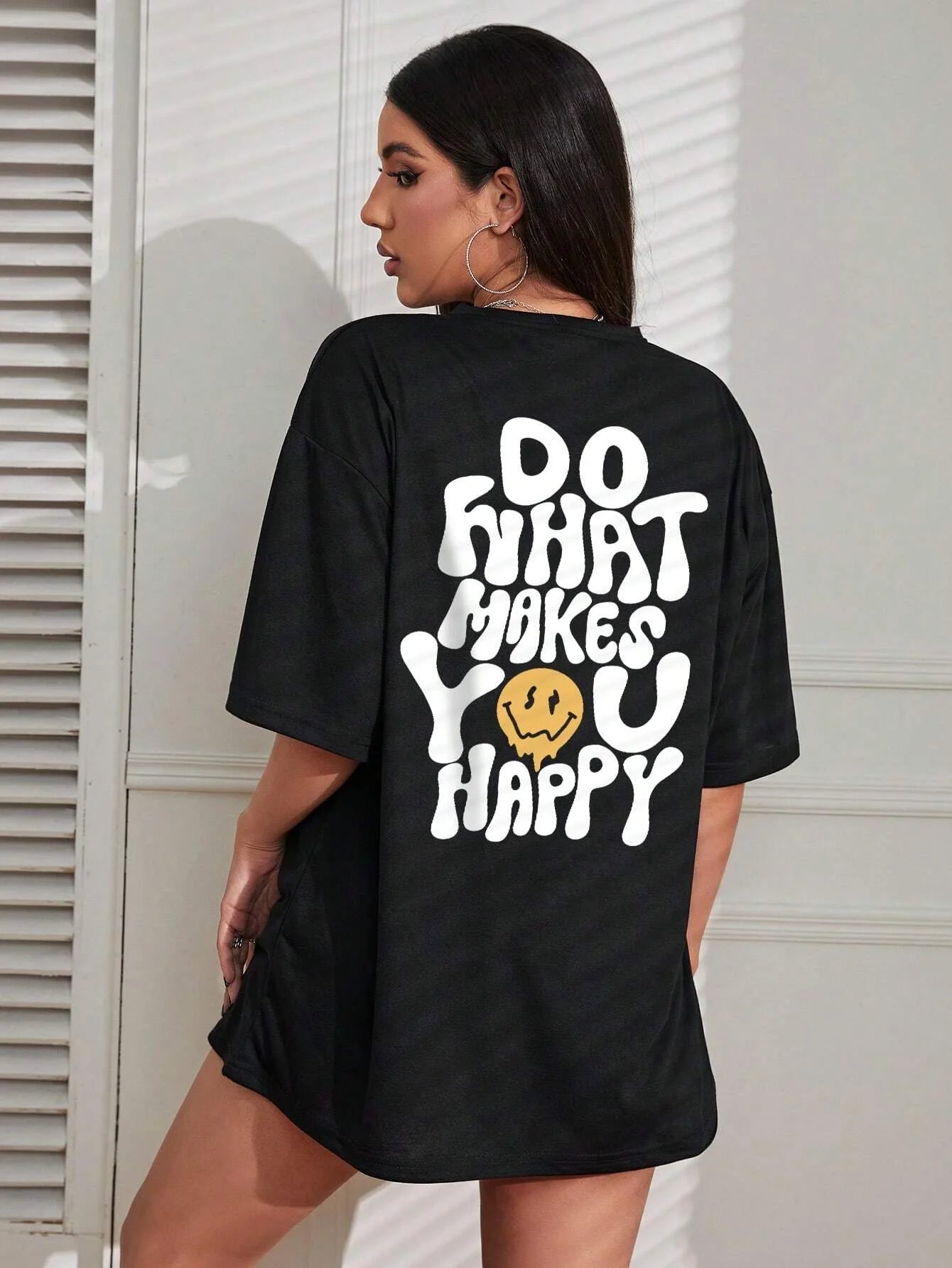 Person wearing a black t-shirt with a motivational quote on the back.