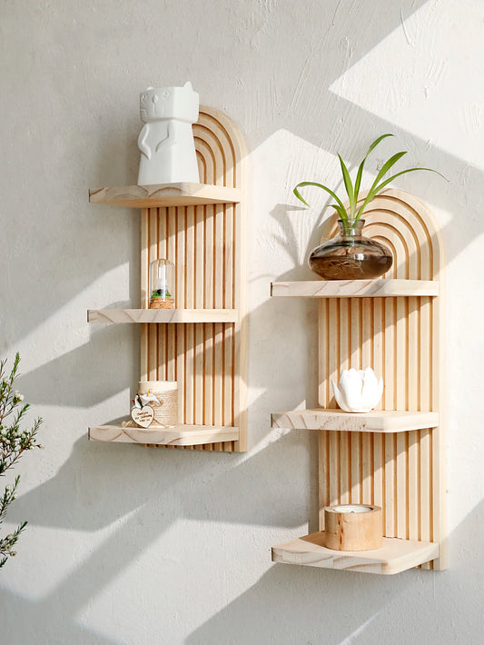 Wooden wall shelves with decorative items against a white wall