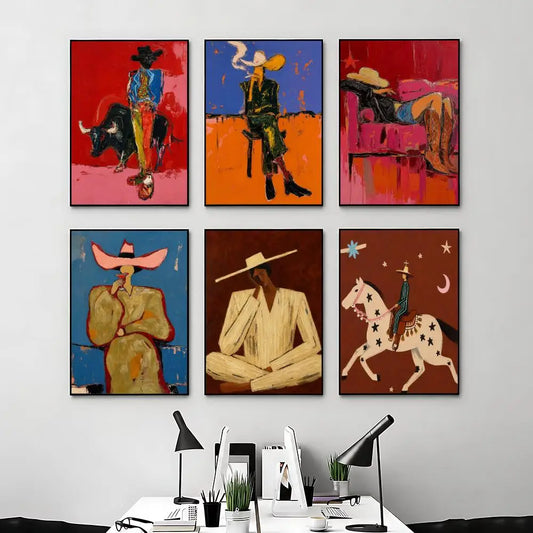 Six framed abstract Western-style art prints are displayed in a 2x3 grid on a light gray wall above a white desk with lamps and office items.