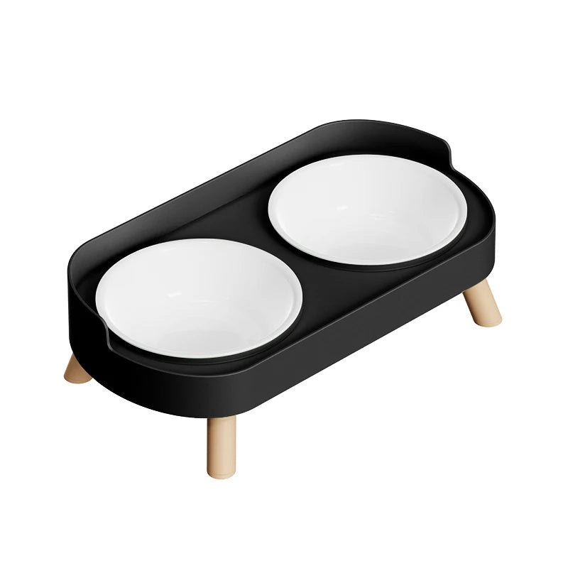 Black pet feeder with two white bowls on a white background