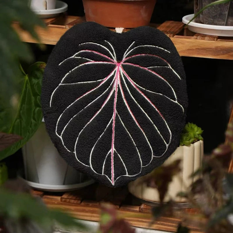 Leaf shaped hanging hand towel made from soft coral fleece fabric displayed beside a bathroom sink