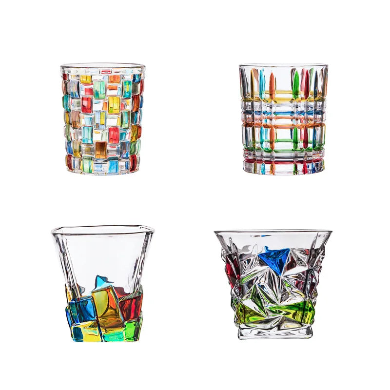 Set of four colorful glass tumblers on a white background
