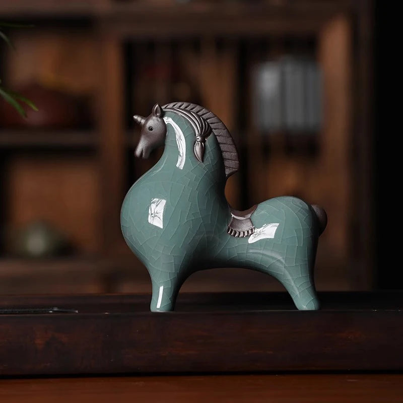 Green ceramic horse figurine on a wooden surface with a blurred background