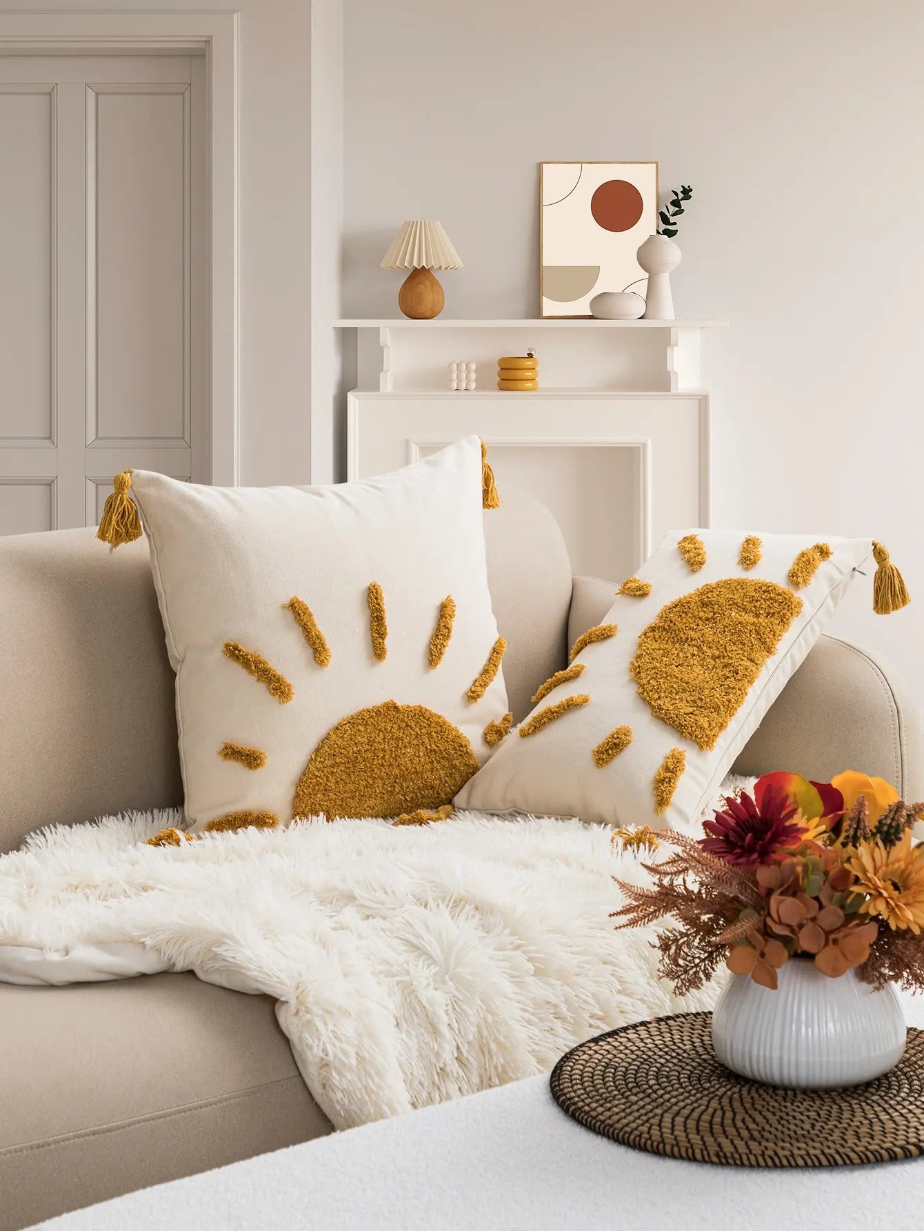 Boho sun tufted cushion cover with tassel corners styled on cozy neutral sofav