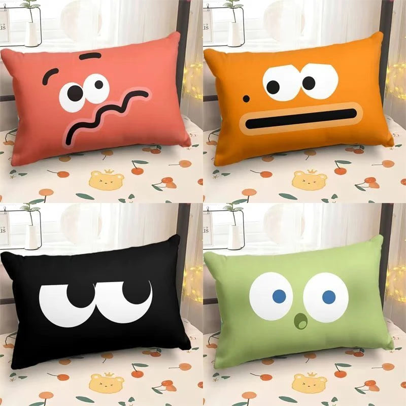 Funny emoji face pillowcases in multiple colours displayed on a bed as decorative rectangular cushion covers
