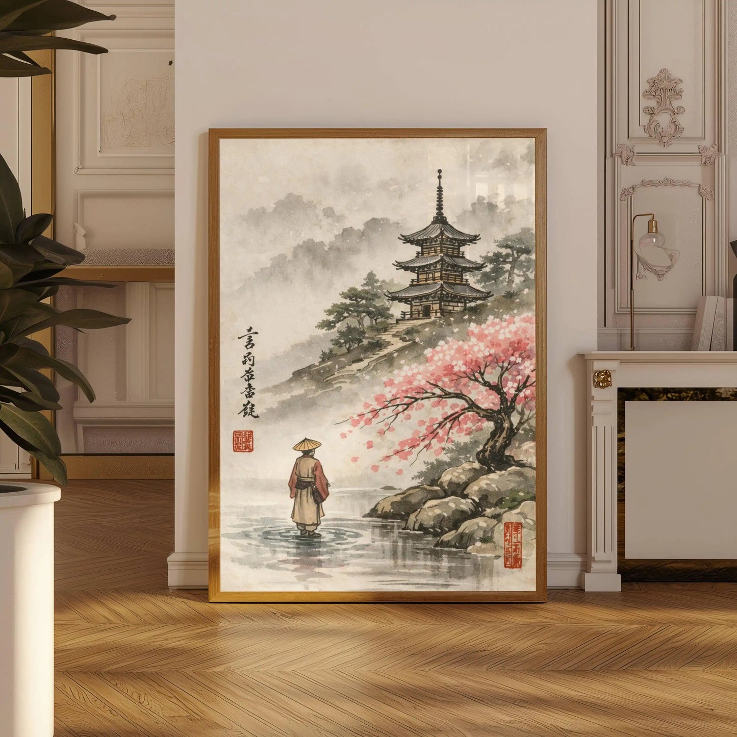 Framed artwork of a traditional Japanese scene with a pagoda and cherry blossom tree in a room.