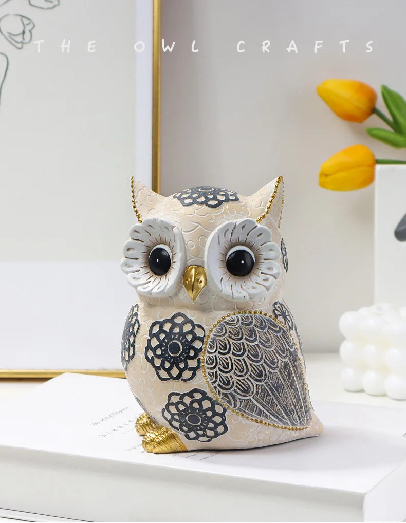 Decorative owl figurine with intricate designs on a white surface, branded 'The Owl Crafts'.