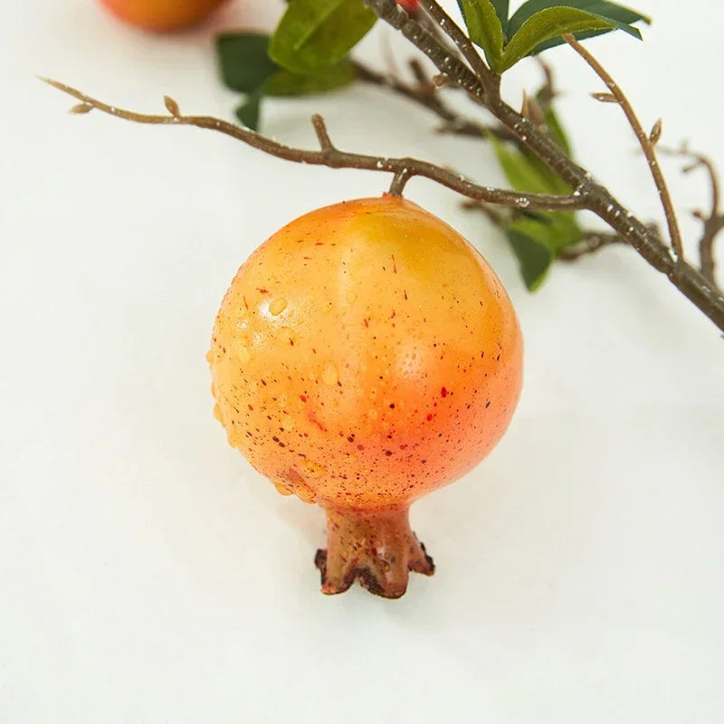 Pomegranate on a white background with green leaves