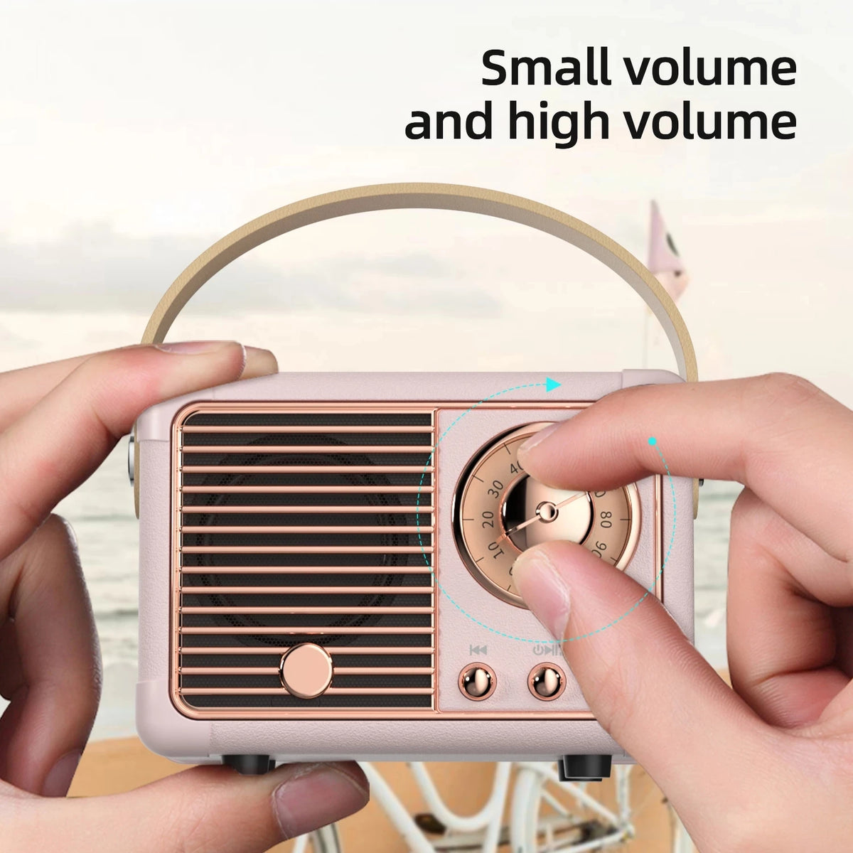 Vintage-style radio with hands adjusting the volume knob, set against a blurred outdoor background.