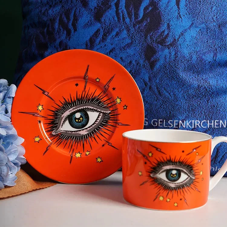 Orange plate and mug set with eye design on a blue textured background