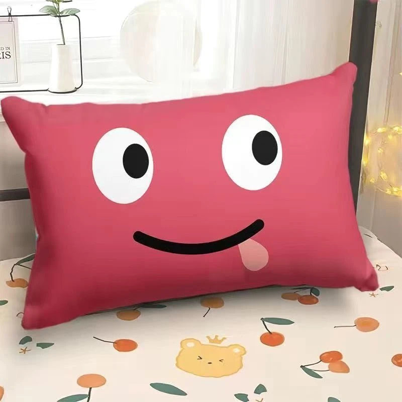 Pink pillow with a smiley face design on a bed with a floral pattern